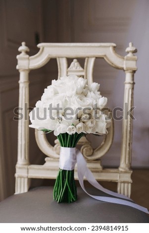 A bouquet of white flowers sitting on top of a table 