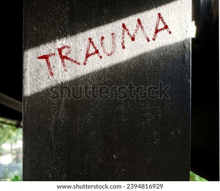 Cement post with handwriting text Trauma -  person's emotional response to a distressing experience,  lasting emotional response results from intensely stressful  events Royalty-Free Stock Photo #2394816929