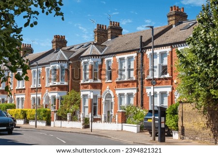 Traditional brick terraced houses in London. England Royalty-Free Stock Photo #2394821321