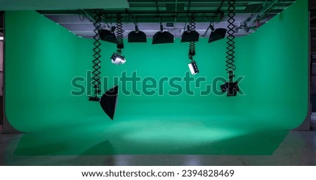 Empty green screen studio with professional lighting equipment Royalty-Free Stock Photo #2394828469