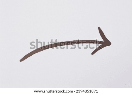Arrow drawn with black marker on white background Royalty-Free Stock Photo #2394851891
