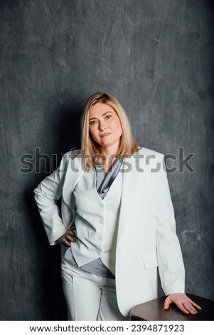 adult woman in white business suit in office