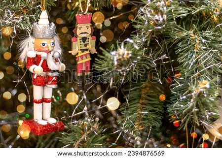 Nutcracker on Christmas tree. Copy space. Postcard.