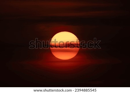 Thin clouds over a setting sun Royalty-Free Stock Photo #2394885545