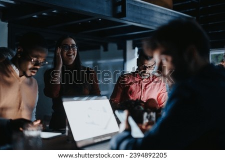 Businesspeople collaboratively analyze reports and discuss strategies for project development and market research in a creative office. They work late to meet deadlines and achieve business growth.