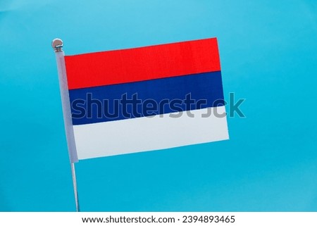 Republika Srpska flag on blue background.