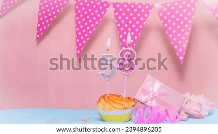 Date of Birth  58. Greeting card in pink shades. Anniversary candle numbers. Happy birthday girl, polka dot garland decoration. Copy space.