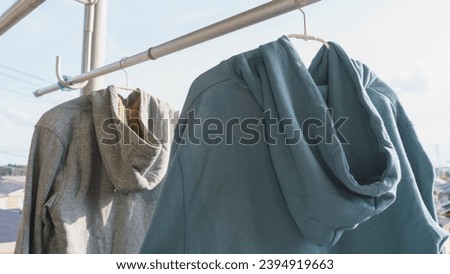 Dry the hoodie in the sun. Royalty-Free Stock Photo #2394919663