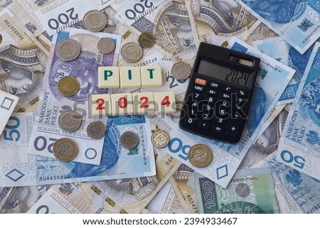 The wording "PIT 2024" concept for personal income taxes 2024 and many Polish banknotes, calculator displaying 2024 on the screen.  Royalty-Free Stock Photo #2394933467