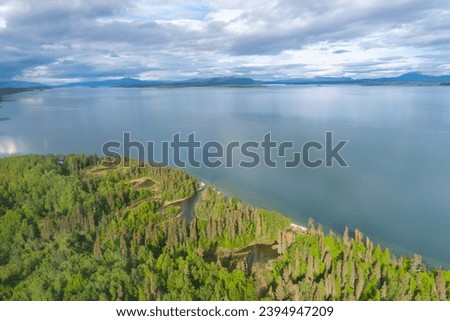 Shoreline of Lake Clark near Port Alsworth, Alaska. Remote wilderness with rugged mountains and alpine lake. Lake Clark National Park and Preserve, Alaska National Interest Lands Conservation Act Royalty-Free Stock Photo #2394947209