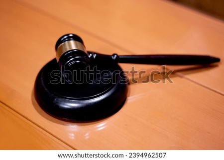 Judicial gavel HAMMER years on a backing on a wooden table, close-up, selective focus Royalty-Free Stock Photo #2394962507