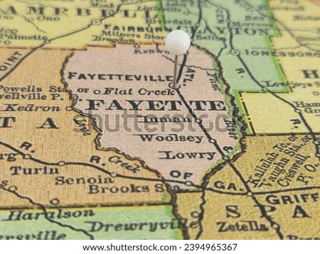 Fayette County, Georgia marked by a white tack on a colorful vintage map. The county seat is located in the city of Fayetteville, GA. Royalty-Free Stock Photo #2394965367