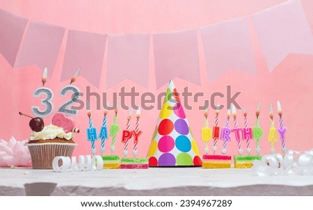 Background date of birth number  32. Anniversary. Beautiful festive background with candles for a girl. Women's congratulations postcard. Happy birthday in pink.