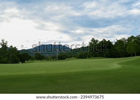 Golf course green with mountain view in behind