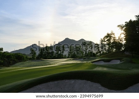 Magnificent landscape of a golf hole showcase in an early morning in summer