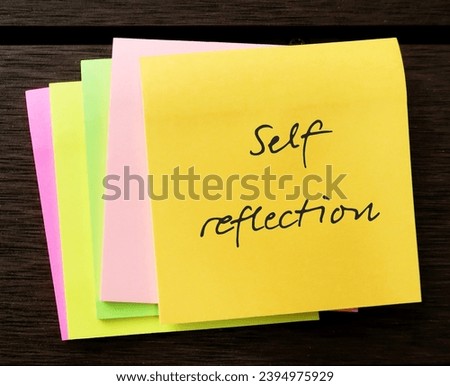 Note pad with handwritten text SELF REFLECTION, mental process to grow self understanding of who you are, values and why you think, feel, act the way you do Royalty-Free Stock Photo #2394975929