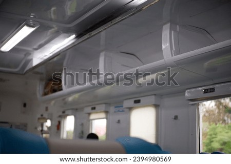 Seats in a rail car, Indonesia, November 30, 2023, train cabin, there are bags and suitcases on the seats, passenger seats, footrests, seat covers, train information boards and walkways, kabin kereta