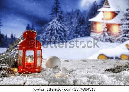 Wooden retro rural desk cover of snow and frost. Chrismtas composiotion decoration on top. Empty space for your product. Blurred landscape of mountains. Winter time and cold december day. 