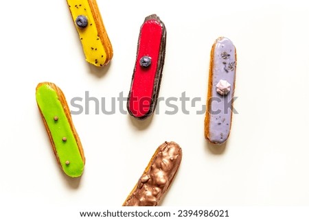 Sweet food pattern with many icing eclairs cakes.
