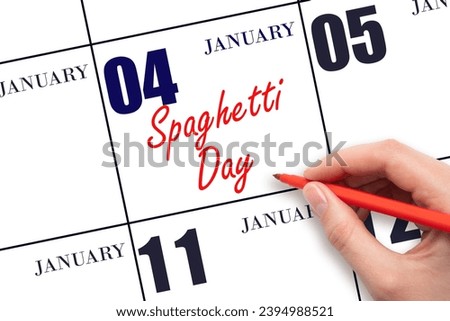 January 4. Hand writing text Spaghetti Day on calendar date. Save the date. Holiday.  Day of the year concept.