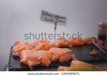 A simple and straightforward presentation of a plate of salmon and other food. The salmon is arranged in the center of the plate, creating an appealing visual composition. Royalty-Free Stock Photo #2394989875