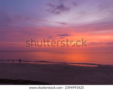 Aerial view colorful reflection of stunning sunset.
beautiful scene with the sun painting the sky above waves 
breaking gently on a sandy
Gradient sweet color. abstract nature background.