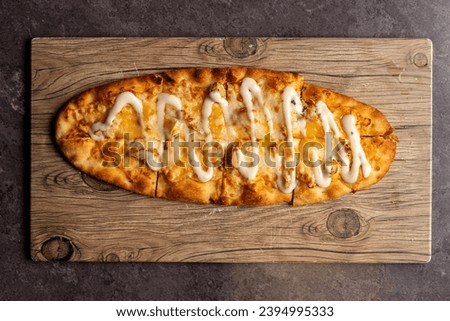 Buffalo chicken flatbread on a board Royalty-Free Stock Photo #2394995333
