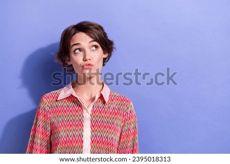 Photo portrait of pretty young girl look skeptical empty space dressed stylish print outfit isolated on violet color background Royalty-Free Stock Photo #2395018313