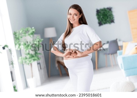Photo of cheerful glad gorgeous lovely pregnant girl mommy mum showing heart love her baby comfort flat indoors Royalty-Free Stock Photo #2395018601
