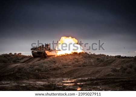 M1 Abrams takes aim and fires at a target down range during gunnery training. Royalty-Free Stock Photo #2395027911