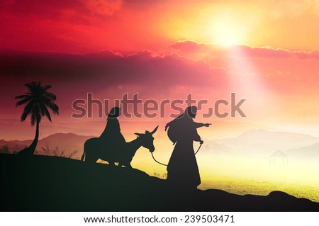 Nativity scene concept: Silhouette Mary and Joseph journeying through the dessert with a donkey on sunset looking for a place to stay
