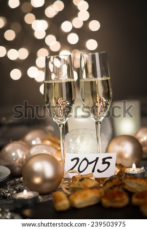 2015 new years eve party table with two champagne flute ribbon and glitter 
