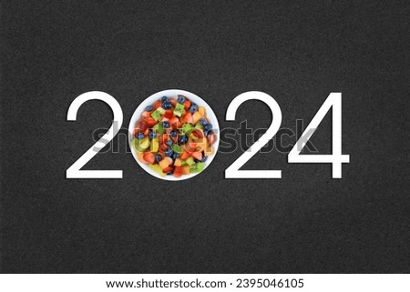 Modern 2024 typography atop a contemporary dark background with a bowl of delicious fresh fruit in place of the 0.