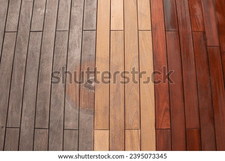 Wood planks texture - weathered with water stain of plant pot, sanded, and freshly oiled ipe deck Royalty-Free Stock Photo #2395073345
