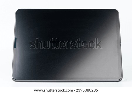 Front view of tablet  screen on stand isolated on white studio background Royalty-Free Stock Photo #2395080235