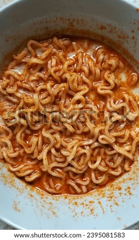 Close-up photo of spicy noodles. Appetizing red spicy sauce.