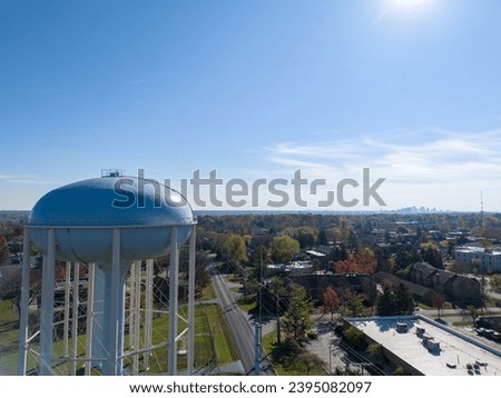 Aerial view of a water tower in Upper Arlington, OH, with Columbus skyline on the horizon. Royalty-Free Stock Photo #2395082097
