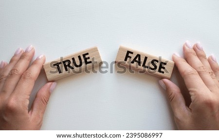 True or False symbol. Concept word True or False on wooden blocks. Businessman hand. Beautiful white background. Business and True or False concept. Copy space