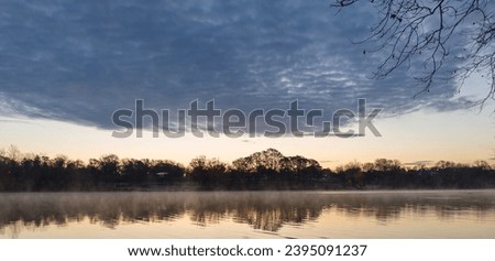 Sunrise at Griggs Reservoir, Upper Arlington, with mist over calm waters. Royalty-Free Stock Photo #2395091237