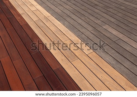 Wood deck diagonal planks- weathered, sanded, and freshly oiled, deck maintenance before and after Royalty-Free Stock Photo #2395096057