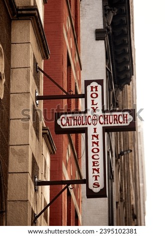 Catholic Church sign hanging in the street in Manhattan