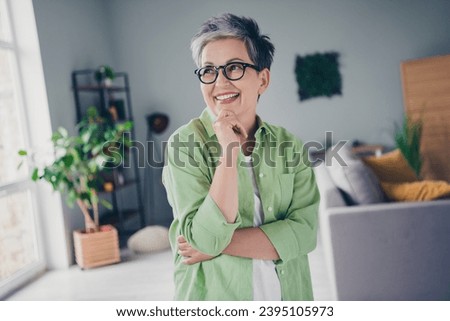 Photo of thoughtful businesswoman wearing khaki shirt touch chin thinking planning looking novelty window side fantasizing ideas indoors Royalty-Free Stock Photo #2395105973