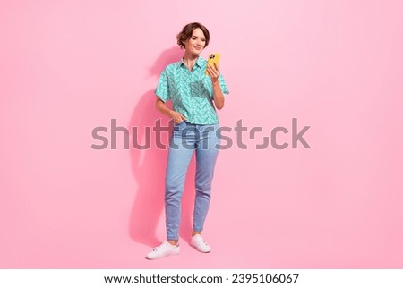 Full size photo of lovely nice girl use smart phone chatting empty space ad isolated on pink color background