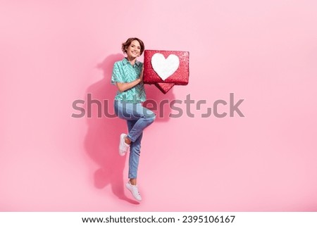 Full size photo of excited energetic girl jump hold like notification collage empty space isolated on pink color background