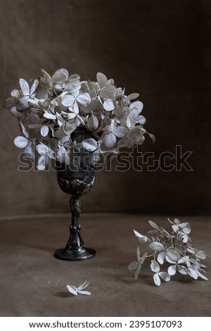 dried hydrangea flowers in a silver glass