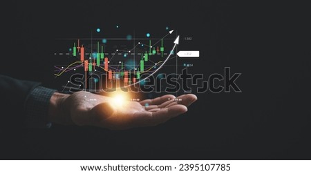 Navigating the complexities of the stock market, a trader or investor relies on a palm-sized device, examining candlestick charts and employing cutting-edge tools to optimize their trading strategies. Royalty-Free Stock Photo #2395107785