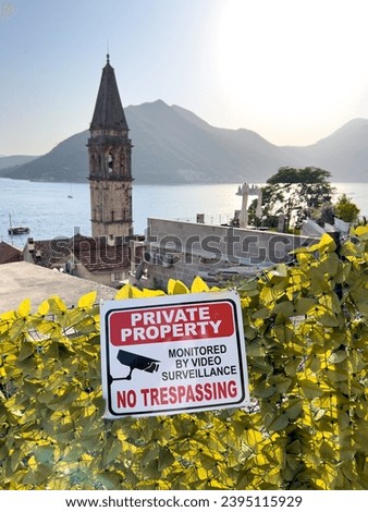 Plaque on the fence around the Church of St. Nicholas in Perast. Caption: Private property. No trespassing