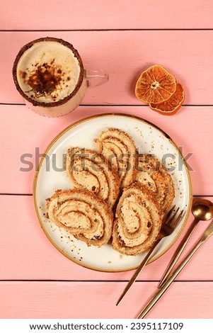 Homemade dessert, stollen or strudel with sweet cream filling, nuts, cinnamon and eggnog. Concept for holiday bakery, seasonal treats and cafe advertising, selective focus