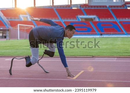 Asian para-athlete with prosthetic blades leg in stadium practicing workout for running competition. Amputee sports man runner practicing running workout. Disabled athlete man sport concept. Royalty-Free Stock Photo #2395119979