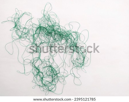 Tangled threads in white isolation. Royalty-Free Stock Photo #2395121785